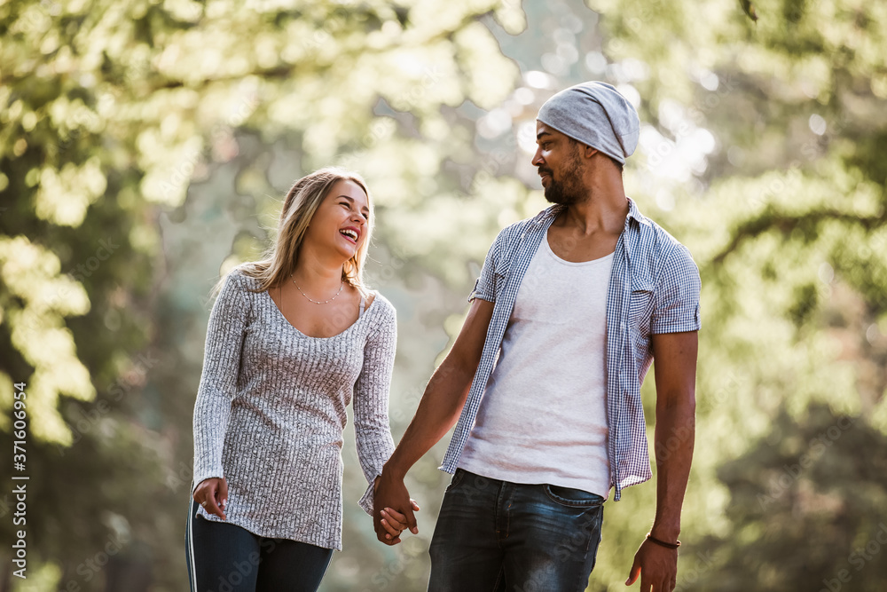 Portrait of happy mixed race couple in walking.