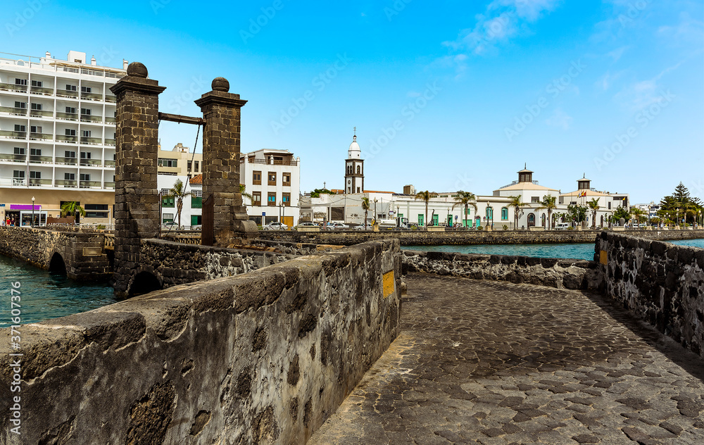 A view of the shoreline in Arrecife, Lanzarote from the causeway to the islet of the English on a sunny afternoon