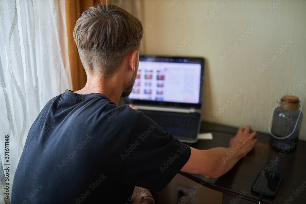A man works at a laptop. The man works at home. Notebook. A man works at a laptop. The man works at home. Notebook.