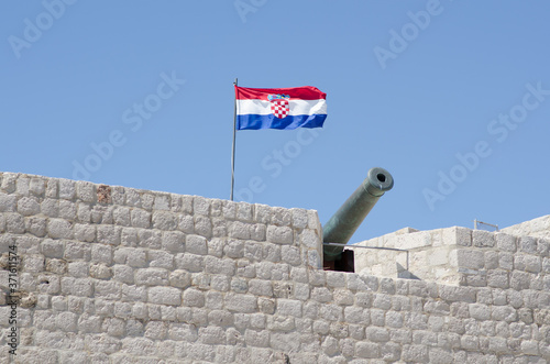 Dubrovnik walls with flag and canon