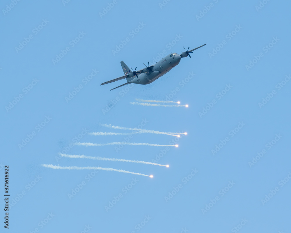 Fototapeta premium C130 Aircraft using counter-measure flares