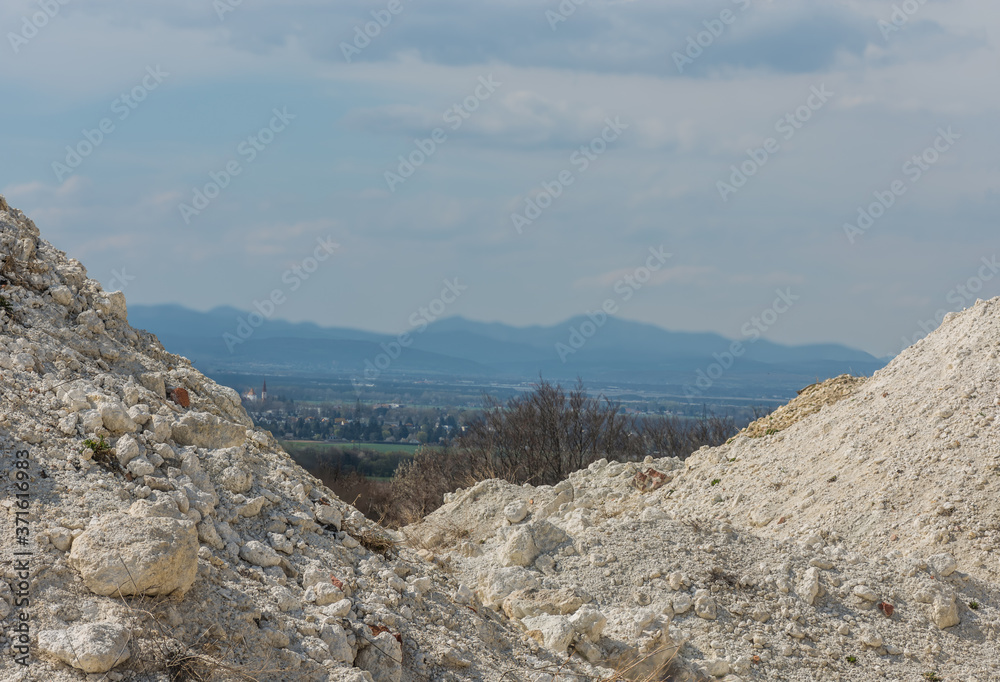 white lime quarry with a landscape in the middle white lime quarry with a landscape in the middle