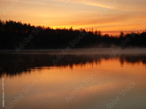 Sunrise above lake with image
