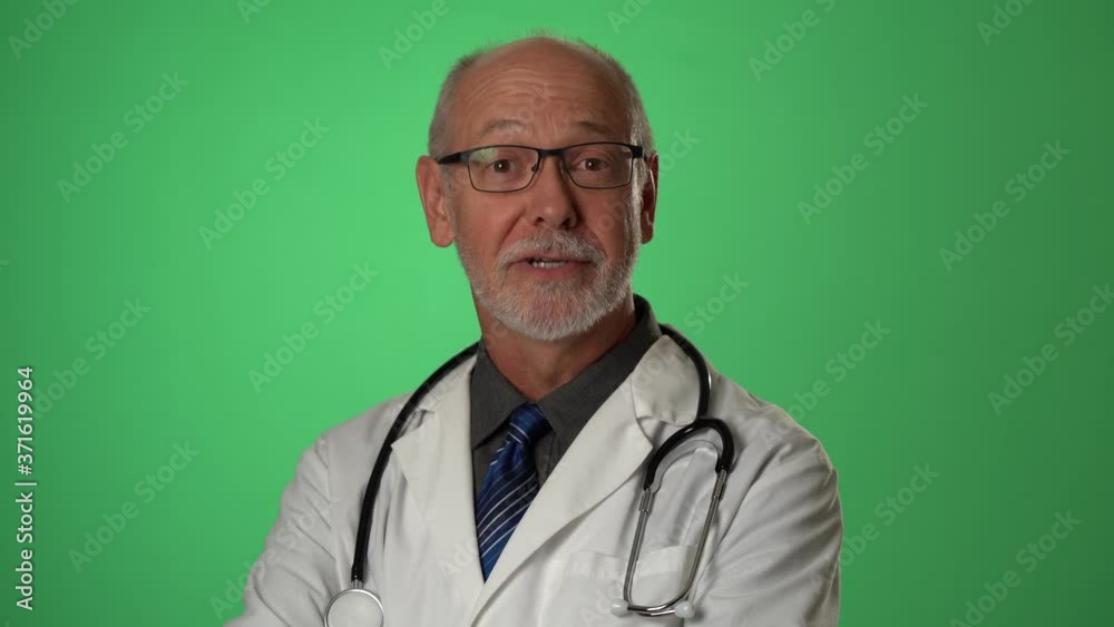 Portrait of experienced gray haired senior medical doctor talking and smiling. Shot on green screen. Portrait of experienced gray haired senior medical doctor talking and smiling. Shot on green screen.