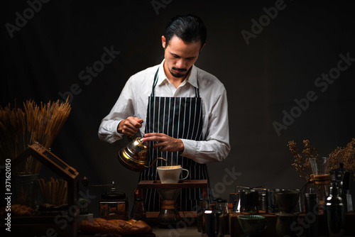 Male barista pours boiling ...