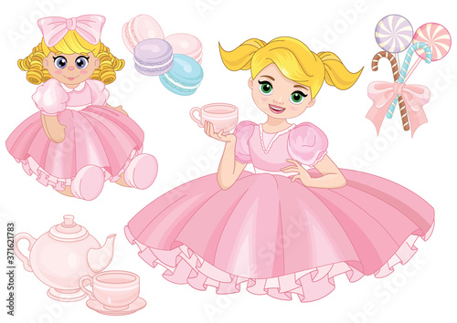 Toddler girl playing tea party with a doll