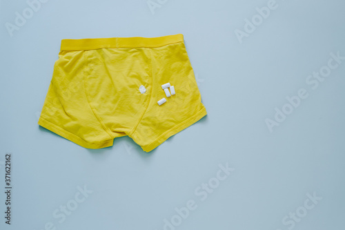 spot of chewing gum on yellow panties.isolated on gray background
