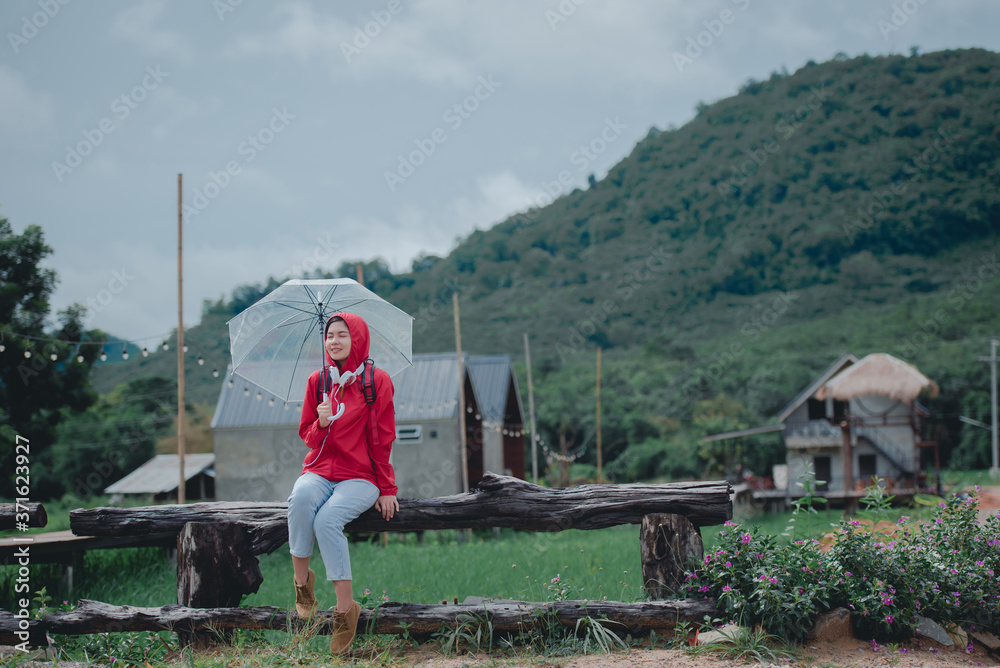 Beautiful young Asian tourists wearing red clothes travel in Thailand She likes to travel in nature. Beautiful young Asian tourists wearing red clothes travel in Thailand She likes to travel in nature.