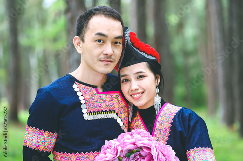 Portrait of Hmong couple with bouquet of flower, Wedding portrait of Hmong couple in the park photo