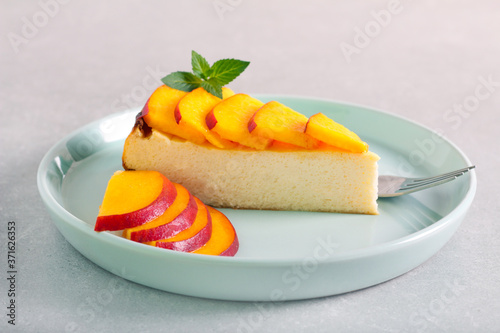 Slice of cheesecake with nectarine topping 