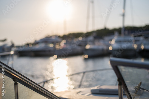 Sailing boats and yachts in marina. sunset defocused background