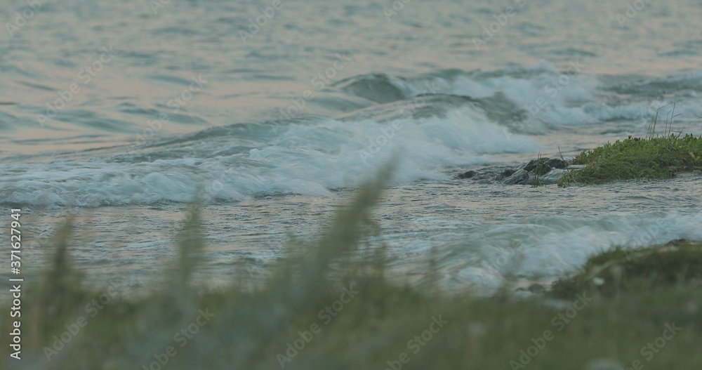 Fototapeta premium waves break on the beach and rocks, Waves taking down from different angles,