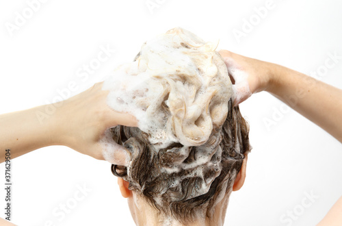 Fototapeta Naklejka Na Ścianę i Meble -  Fingers in hair with foam from shampoo. close up .selective focus