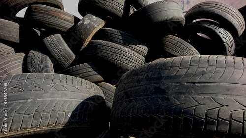 Pile of tires that are not used in the junkyard, abstract background
