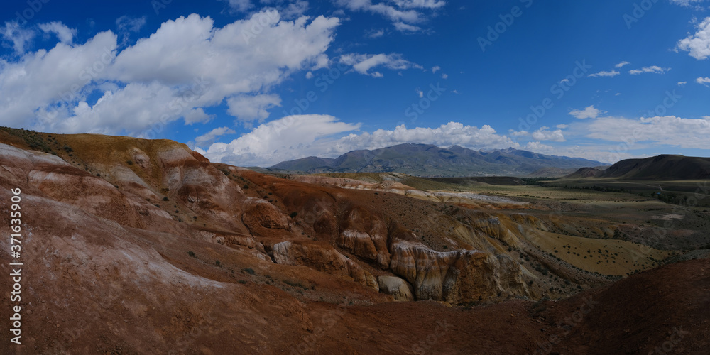 Panorama of the mountains. Magnificent views of the Altai mountains of red against the blue sky. Siberia, Altai, Mongolia.