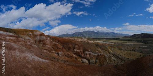 Panorama of the mountains. Magnificent views of the Altai mountains of red against the blue sky. Siberia, Altai, Mongolia.