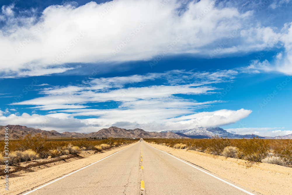 Long Straight Road Running Through a Desert Landscape 