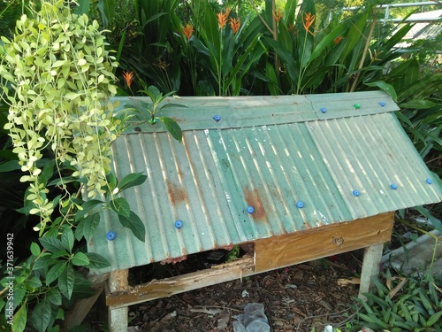 A Joss house in a village with green trees in Thailand
