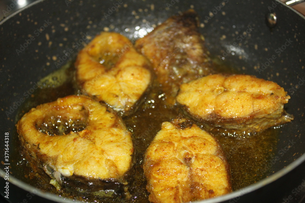 delicious fish fry in hot oil on pan tasty rohu fish frying on hot pan
