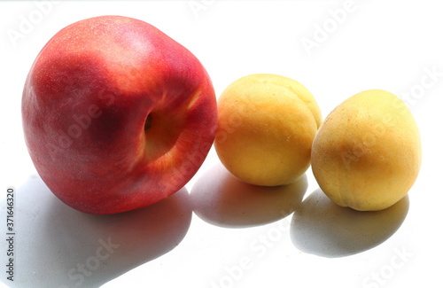 Fruits of ripe, fragrant, fresh nectarine and apricot close-up on a white background