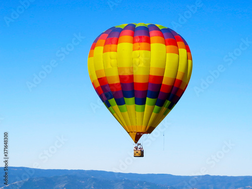 Colorful Balloon flyng in the blue sky © Diego