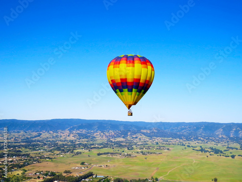 Colorful Balloon flyng in the blue sky © Diego