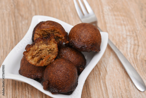 Unniyappam, Unni appam traditional Kerala snack sweet food fried in coconut oil for Onam, Vishu festival. made from rice, jaggery, banana, roasted coconut pieces, cardamom photo