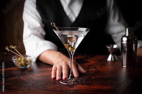 bartender serving martini in glass at bar photo