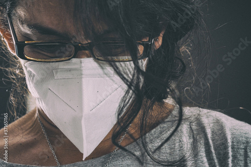 Young brunette latina woman wearing fp2 face mask while at work office to protect against contagion  photo