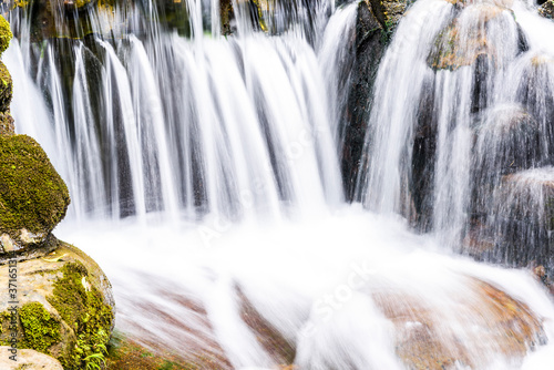 The stones under the waterfall, close-up waterfall as background.