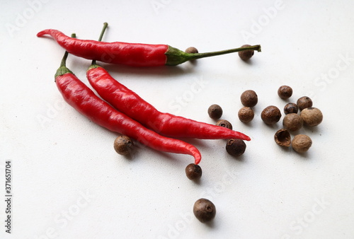 bitter red and black pepper sweet peas close-up on a white background, spicy seasonings