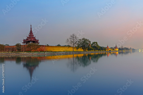 Mandalay Palace at the twilight, with its reflection in the water, Mandalay, Myanmar © MehmetOZB