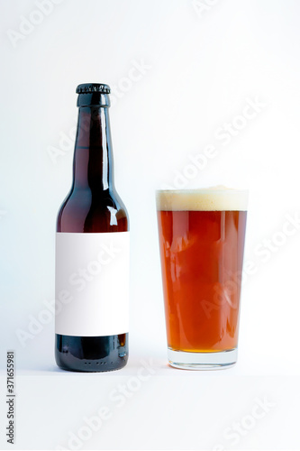 Beer Bottle Mock-Up with glass of altbier and foam. Blank Label.