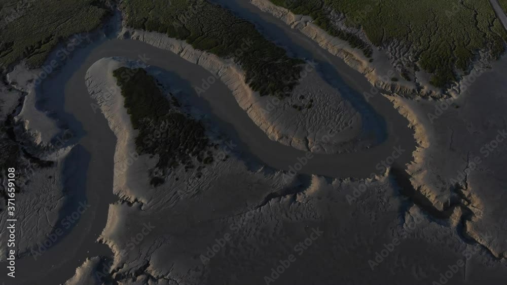 cinematic aerial drone shot of vivier sur mer dark sand beach
