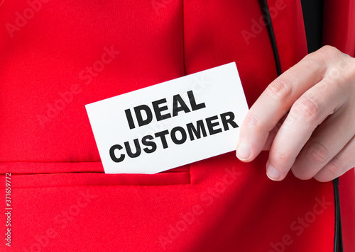 Businessman putting a card with text ideal customer in the pocket