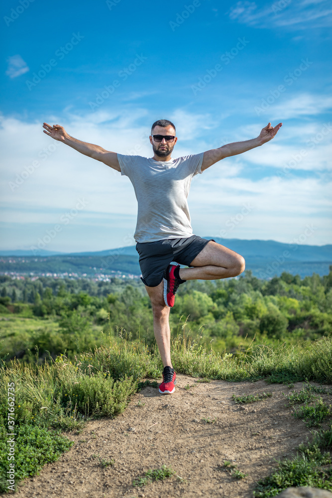 Young bearded man traveler feet standing alone with sunset mountains on background. Lifestyle travel concept outdoor. Young bearded man traveler feet standing alone with sunset mountains on background. Lifestyle travel concept outdoor.