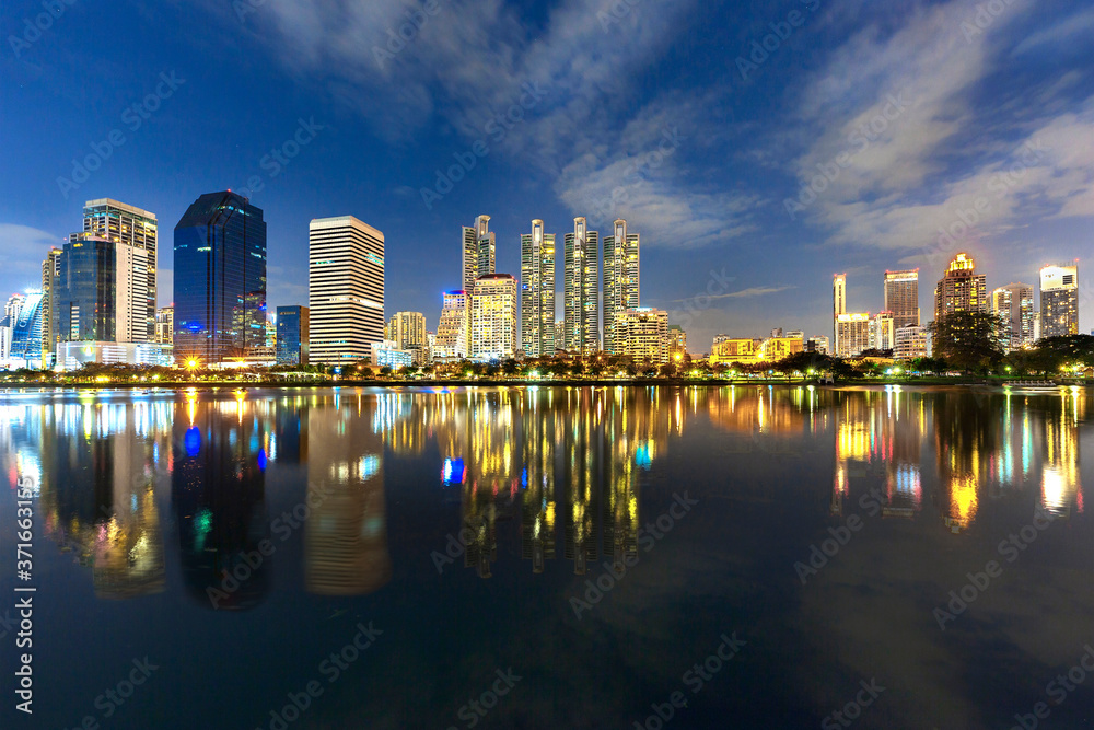 Naklejka premium Skyline of Bangkok with reflections in the lake, at the twilight, Thailand