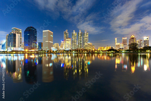 Skyline of Bangkok with reflections in the lake, at the twilight, Thailand