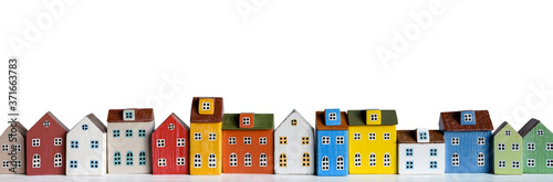 Row of wooden miniature colorful retro houses on white background