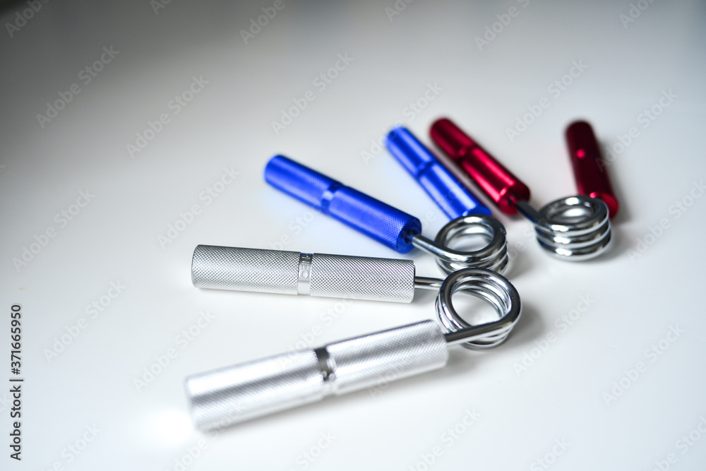 Expanders of different colors depending on the load with or without a hand. Sports and physical activity Expanders of different colors depending on the load with or without a hand. Sports and physical activity