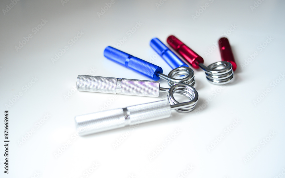 Expanders of different colors depending on the load with or without a hand. Sports and physical activity Expanders of different colors depending on the load with or without a hand. Sports and physical activity