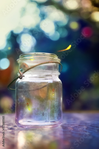Fireflies in a jar at dusk