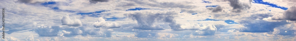 Beautiful summer landscape - view of the morning sky with floating clouds, panorama, banner Beautiful summer landscape - view of the morning sky with floating clouds, panorama, banner