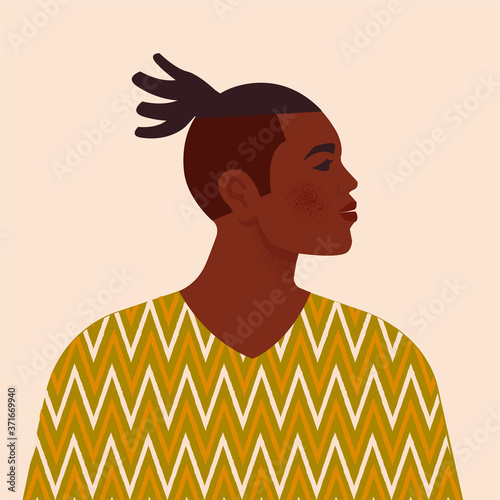 Handsome black man. Young african american. Portrait of young guy with hair. Side view. Isolated on a beige background.