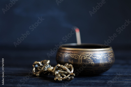 Wallpaper Mural Symbols of Buddhism. Antique sound bowl and vajra on the dark table. Copy space. Torontodigital.ca