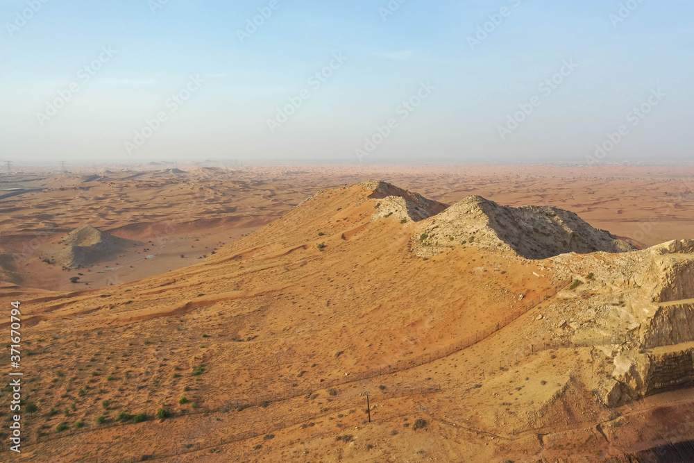 Naklejka premium Drone view of Dry Desert in Dubai with Sand Ripples, High Dune Desert in United Arab Emirates 