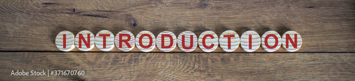 White small wooden circles with word 'introduction' on wood background. Business concept. photo
