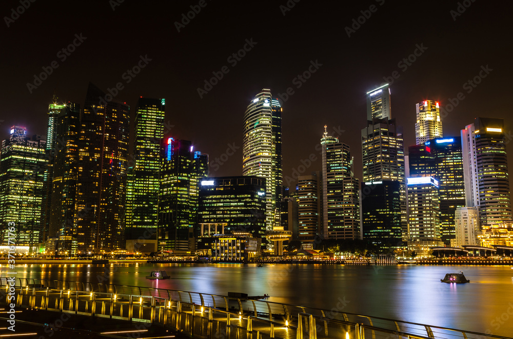 Metropolitan Singapore Skyline Illuminates at Night on Marina Bay