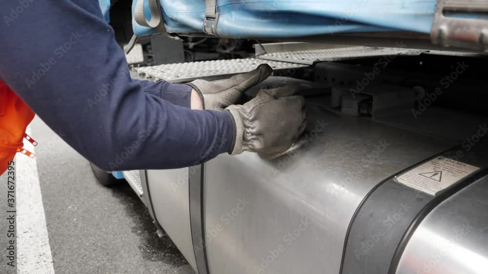 Truck man driver manipulating fuel filler cap. Truck man driver manipulating fuel filler cap.