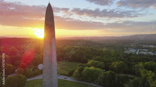 Aerial 4k video of Bennington Monument. Fast-paced drone shot flying upwards with tilt down and lens flare.